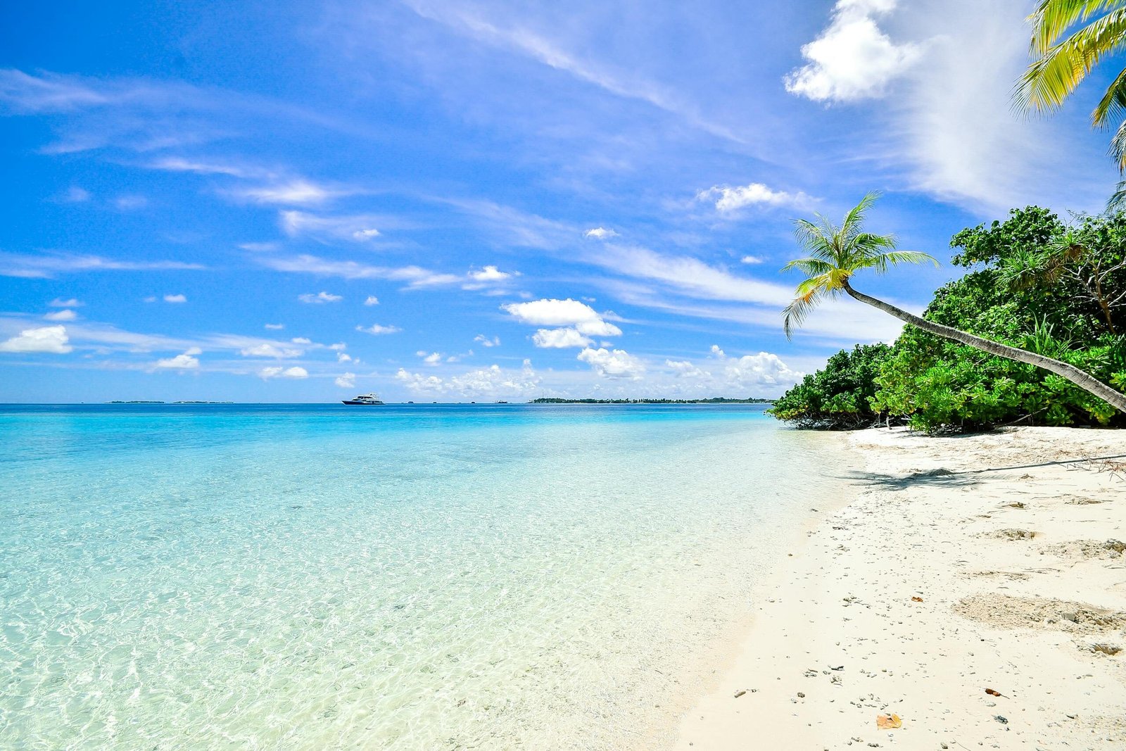 Stunning beach in Laamu Atoll, Maldives, with turquoise waters and clear skies.